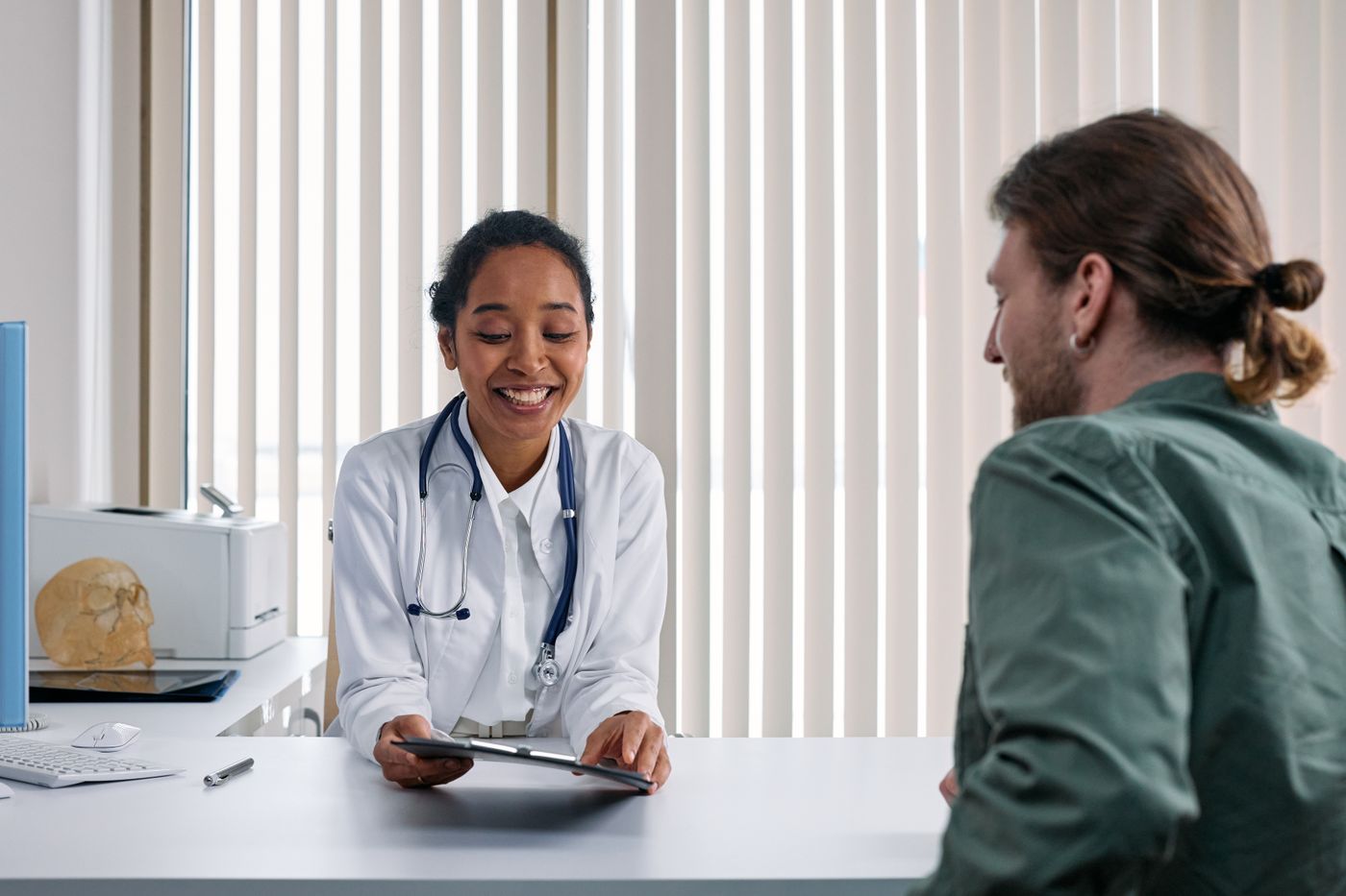A clinician spending time with a patient during a consultation